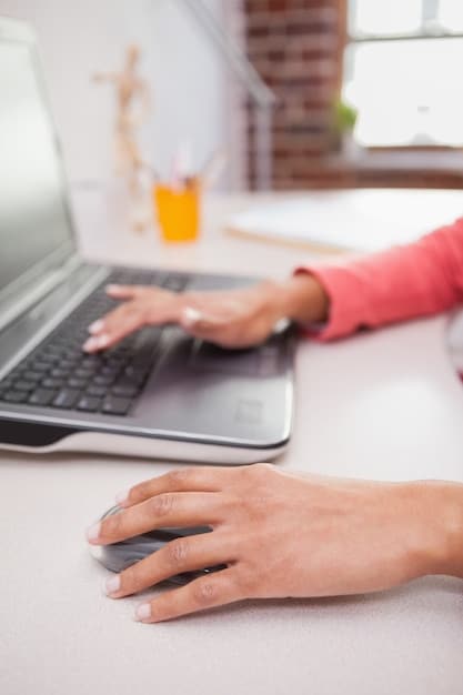 A close-up of a freelancer's hands typing on a keyboard, with a blurred background of a home office setup, emphasizing the focus required for effective email communication.
