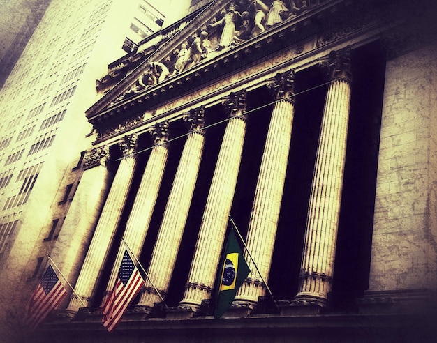 A split image. The left side shows a pristine US Treasury building, symbolizing government bonds and stability. The right side displays a bustling city skyline with corporate logos, representing corporate bonds and potential growth.