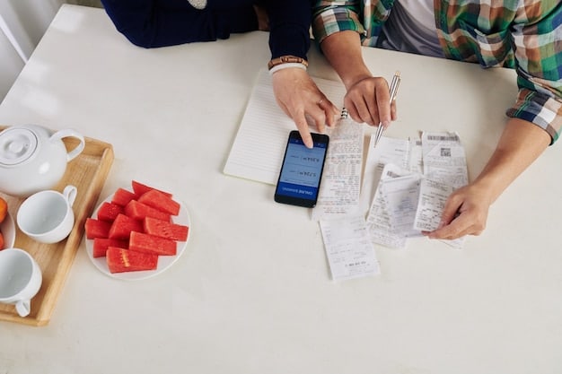 A person using a smartphone to scan a receipt. There are several organized receipts on a desk beside the smartphone, including pens and a small notebook for jotting down additional expense details.