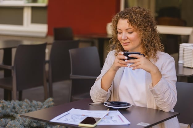 A person tracking expenses using a budgeting app on their smartphone while sitting at a coffee shop. They are comparing receipts with the app interface to ensure accuracy.