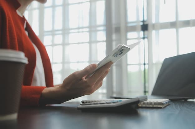 A person using a smartphone to make a call, with a blurry financial document in the background, symbolizing remote financial communication.