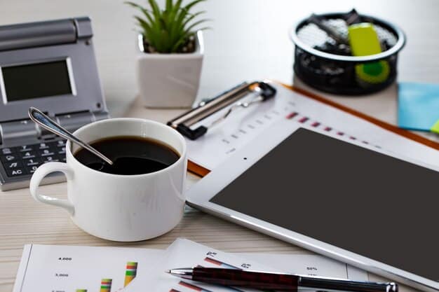 A neatly organized desk with a budget spreadsheet open on a laptop, a pen, and a cup of tea, indicating financial planning and organization.