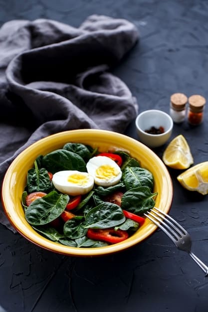 A vibrant, close-up shot of a salad bowl filled with fresh, diverse vegetables like spinach, bell peppers, cherry tomatoes, and cucumber, with a light vinaigrette on the side.