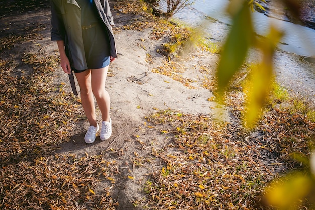 A person's feet in comfortable walking shoes are shown on a scenic path, with soft focus on the blurred natural background, suggesting mindful movement and health.