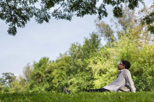 A person peacefully meditating outdoors, perhaps in a park, symbolizing stress reduction and mindfulness.
