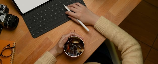 A close-up of a person's hands typing on a laptop keyboard, surrounded by documents, pens, and a coffee cup, symbolizing the detailed and focused work involved in writing a grant proposal.
