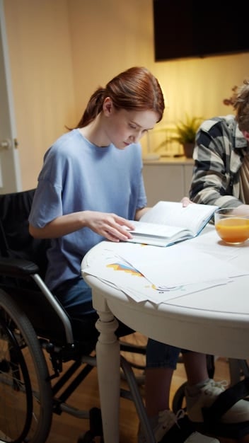 A young person with a disability working with a career counselor, reviewing educational and job opportunities, symbolizing transition planning.