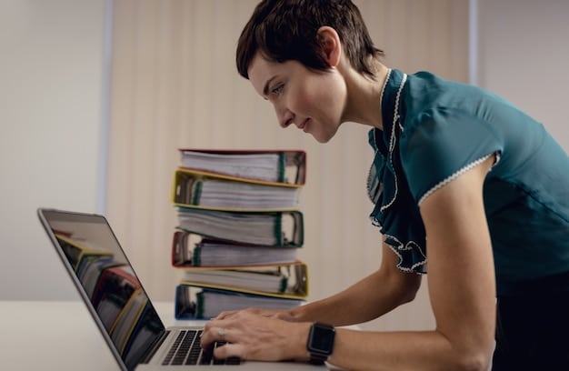 A student meticulously organizing physical and digital documents on a desk, with folders labeled 