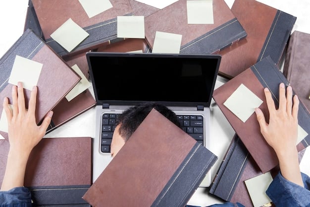 A close-up of hands typing on a laptop, surrounded by open books and notes, symbolizing research and academic work often supported by grants.