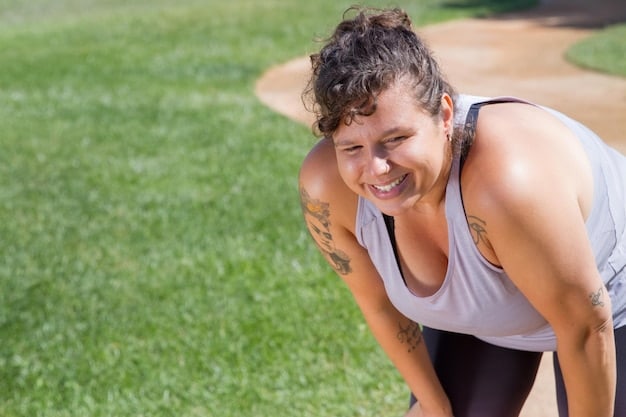 A person smiling victoriously after completing a workout, with a blurred natural background, symbolizing sustained effort and positive results in health.