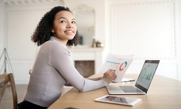A person happily managing their budget on a laptop, with a graph showing decreasing loan payments, symbolizing the financial relief provided by the SAVE plan.