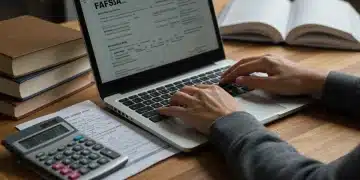 Student applying for FAFSA on laptop with financial aid forms